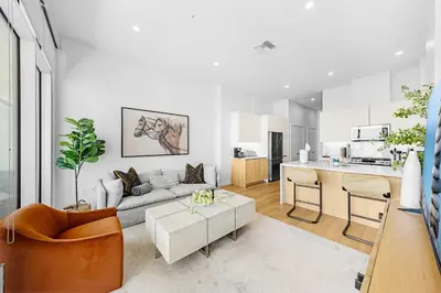 a living room with a couch and a table at Marbella Lane - Panoramic Splendid Ocean Views in Long Beach