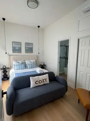 a bedroom with a bed and a couch at Marbella Lane - Lovely DWNTN Getaway LongBeach in Long Beach