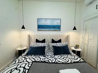 a bedroom with a large bed with black and white pillows at Marbella Lane - Lovely DWNTN Getaway LongBeach in Long Beach