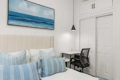 a bedroom with a bed and a desk with a chair at Marbella Lane - Cityside Haven w Touch of Charm in Compton