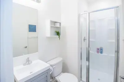 a white bathroom with a toilet and a shower at Cozy Private Studio, Private Entry in USC DPS Zone - DQA6 in Los Angeles