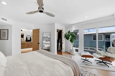 a bedroom with a bed and a ceiling fan at Moonstone Beach House Oceanview Luxe Retreat in Manhattan Beach