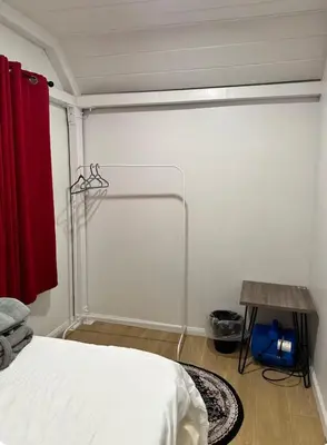 a bedroom with a bed and a red curtain at Naryn Guest House 3 in Los Angeles
