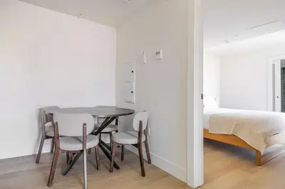 a dining room with a table and chairs and a bed at Blueground East Hollywood rooftop nr Griffith Park LAX-1335 in Los Angeles