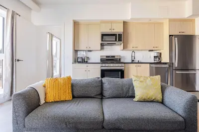a living room with a gray couch with yellow pillows at Blueground East Hollywood rooftop nr Griffith Park LAX-1335 in Los Angeles