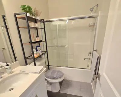 a bathroom with a shower and a toilet and a sink at The Savi Suite in Corona