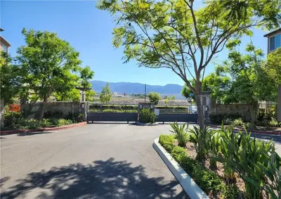 a parking lot with a tree in the middle at The Savi Suite in Corona
