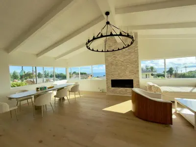 a living room with a dining table and a chandelier at Ocean View Luxury 5BR Modern Coastal Home in Rancho Palos Verdes