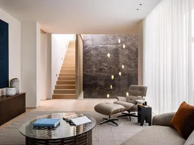 a living room with a couch and a chair and a table at Stradella Mansion in Los Angeles