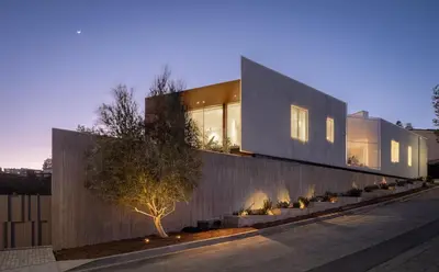 a house with a concrete wall and a tree at Stradella Mansion in Los Angeles