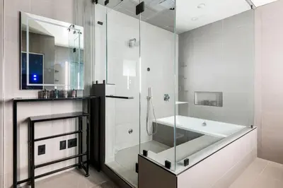 a bathroom with a shower and a tub and a sink at Northstar Premium Ocean Penthouse in Los Angeles