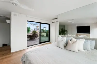 a bedroom with a large bed with white pillows at Northstar Premium Ocean Penthouse in Los Angeles