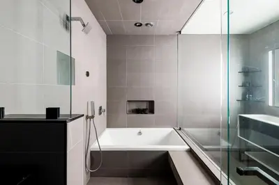 a bathroom with a tub and a glass shower at Northstar Premium Ocean Penthouse in Los Angeles