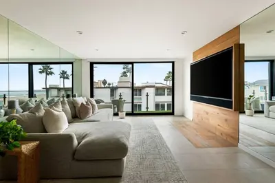 a living room with a large couch and a flat screen tv at Northstar Premium Ocean Penthouse in Los Angeles