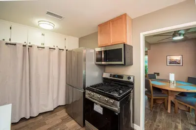 a kitchen with a stove top oven next to a table at Welcome to your home at the Orange Circle in Orange