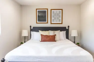 a bedroom with a large white bed with two lamps at Escape in Modern 4BR Home Sleeps 10 with Parking in Burbank