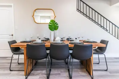 a dining room with a wooden table and chairs at Escape in Modern 4BR Home Sleeps 10 with Parking in Burbank