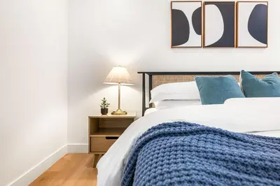 a bedroom with a bed with a blue blanket at Charming LA Gem by SOFI, Games & Close to it ALL in Los Angeles