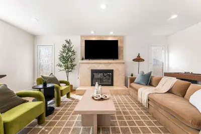 a living room with a couch and a fireplace at Charming LA Gem by SOFI, Games & Close to it ALL in Los Angeles