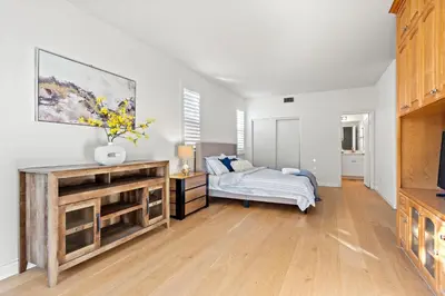 a bedroom with a bed and a dresser in it at Luxury Hilltop Home Spacious Private Backyard in Rowland Heights