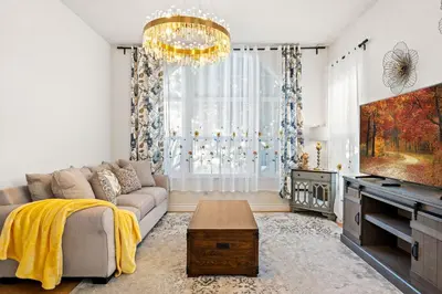 a living room with a couch and a tv at Luxury Hilltop Home Spacious Private Backyard in Rowland Heights