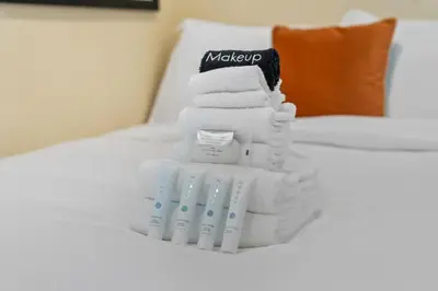 a pile of towels sitting on top of a bed at New Listing Burbank Retreat by Colby & Conrad in Burbank