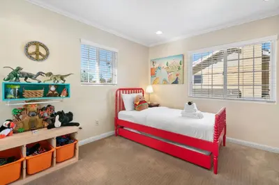 a bedroom with a red bed and a desk at New Listing Burbank Retreat by Colby & Conrad in Burbank