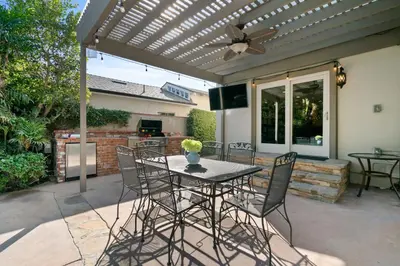 a patio with a table and chairs and a ceiling fan at New Listing Burbank Retreat by Colby & Conrad in Burbank