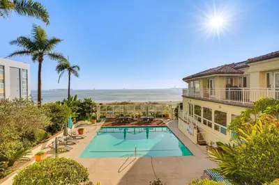 an overhead view of a swimming pool and the beach at Beachfront Living in Long Beach 2,500 Sq Ft Condo in Long Beach
