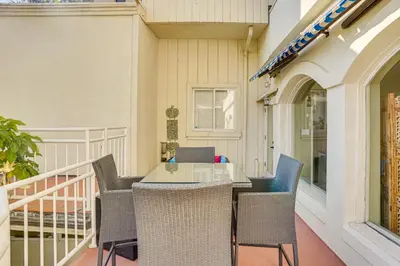 a patio with a table and chairs on a balcony at Beachfront Living in Long Beach 2,500 Sq Ft Condo in Long Beach