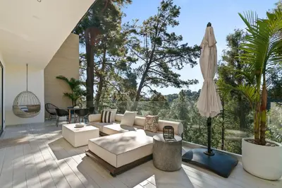 a living room with a couch and an umbrella at New Listing Sunset Retreat by Colby&Conrad in Los Angeles
