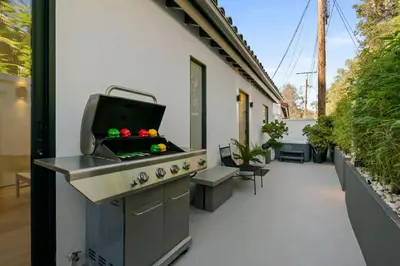 a outdoor kitchen with a grill on a patio at New Listing Sunset Retreat by Colby&Conrad in Los Angeles