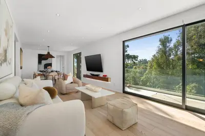 a living room with white furniture and a large window at New Listing Sunset Retreat by Colby&Conrad in Los Angeles