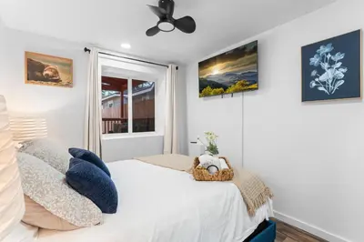 a bedroom with a bed and a window at Tall Pines Retreat Large Patio w BBQ and Firepit! in Big Bear City Airport