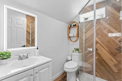 a bathroom with a toilet and a glass shower at Tall Pines Retreat Large Patio w BBQ and Firepit! in Big Bear City Airport