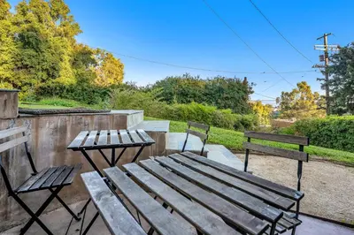 two benches and a wooden table and two chairs at Ridpath Retreat Guest House in Los Angeles