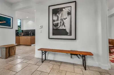 a bench in a room with a picture on the wall at Ridpath Retreat Guest House in Los Angeles