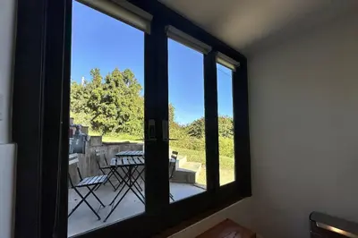 a room with a window with a view of a patio at Ridpath Retreat Guest House in Los Angeles