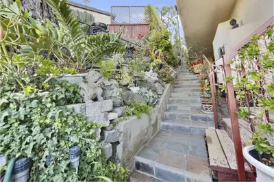 a garden with plants and a stairway at Secret Stairs Family in Los Angeles
