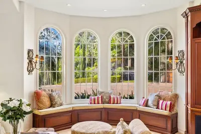 a living room with windows and a bench with pillows at Marbella Lane - Tranquil Country Escape Getaway in Placentia