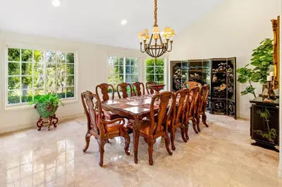 a dining room with a wooden table and chairs at Marbella Lane - Tranquil Country Escape Getaway in Placentia