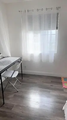 a desk and a chair in a room with a window at Huge bedroom with shared bathroom in Ontario
