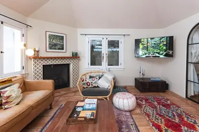 a living room with a couch and a fireplace at Lush Venice Beach Oasis Home -just steps to beach in Los Angeles