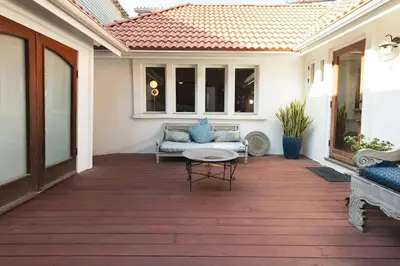 a patio with a couch and a table at Lush Venice Beach Oasis Home -just steps to beach in Los Angeles