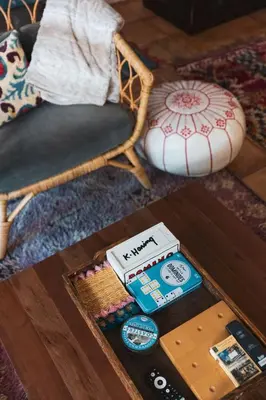 a coffee table with a book and a chair at Lush Venice Beach Oasis Home -just steps to beach in Los Angeles