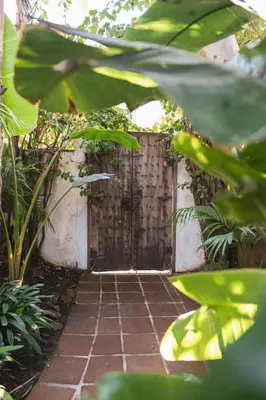 a door in a garden with a brick walkway at Lush Venice Beach Oasis Home -just steps to beach in Los Angeles