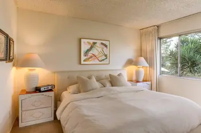 a bedroom with a bed with two lamps and a window at NEW Vintage Canyon Retreat in Mount Washington in Los Angeles