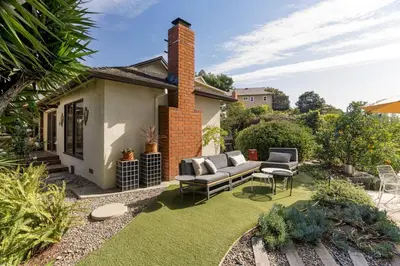 a backyard with a patio furniture and grass at NEW Vintage Canyon Retreat in Mount Washington in Los Angeles