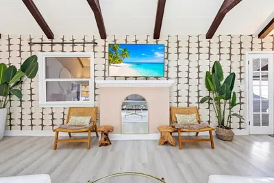 a living room with two chairs and a fireplace at Bel Air Very Private and Comfy Home with Jacuzzi in Los Angeles