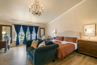 a large bedroom with a bed and a couch at Marbella Lane - Captivating Home w Pool in Rowland Heights